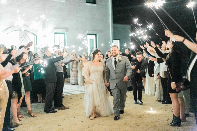 plus size bride and groom doing having a sparkler exit