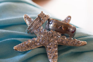 jeweled star fish with wedding bands and wedding ring