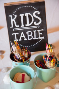 nautical diy table centerpiece, bouquet, starfish, kid table, chalkboar sign, crayons candy