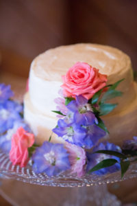 wedding cake, pink and purple flowers