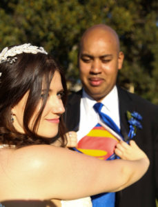 plus size bride with groom in his superman tshirt