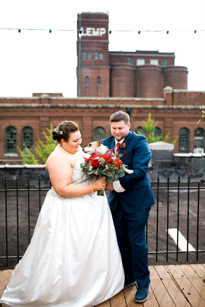 plus size bride wearing A-line dress and groom wearing navy suit
