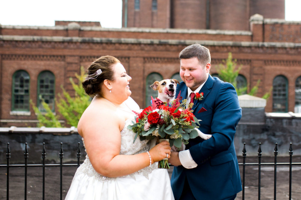 plus size bride and groom with dog wearing a flower collar