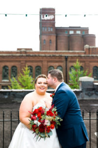 plus size bride wearing A-line dress and groom wearing navy suit