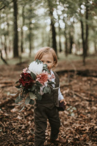 child holding wedding bouquet