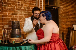 plus size bride, red wedding dress, wedding cake, velvet table cloth