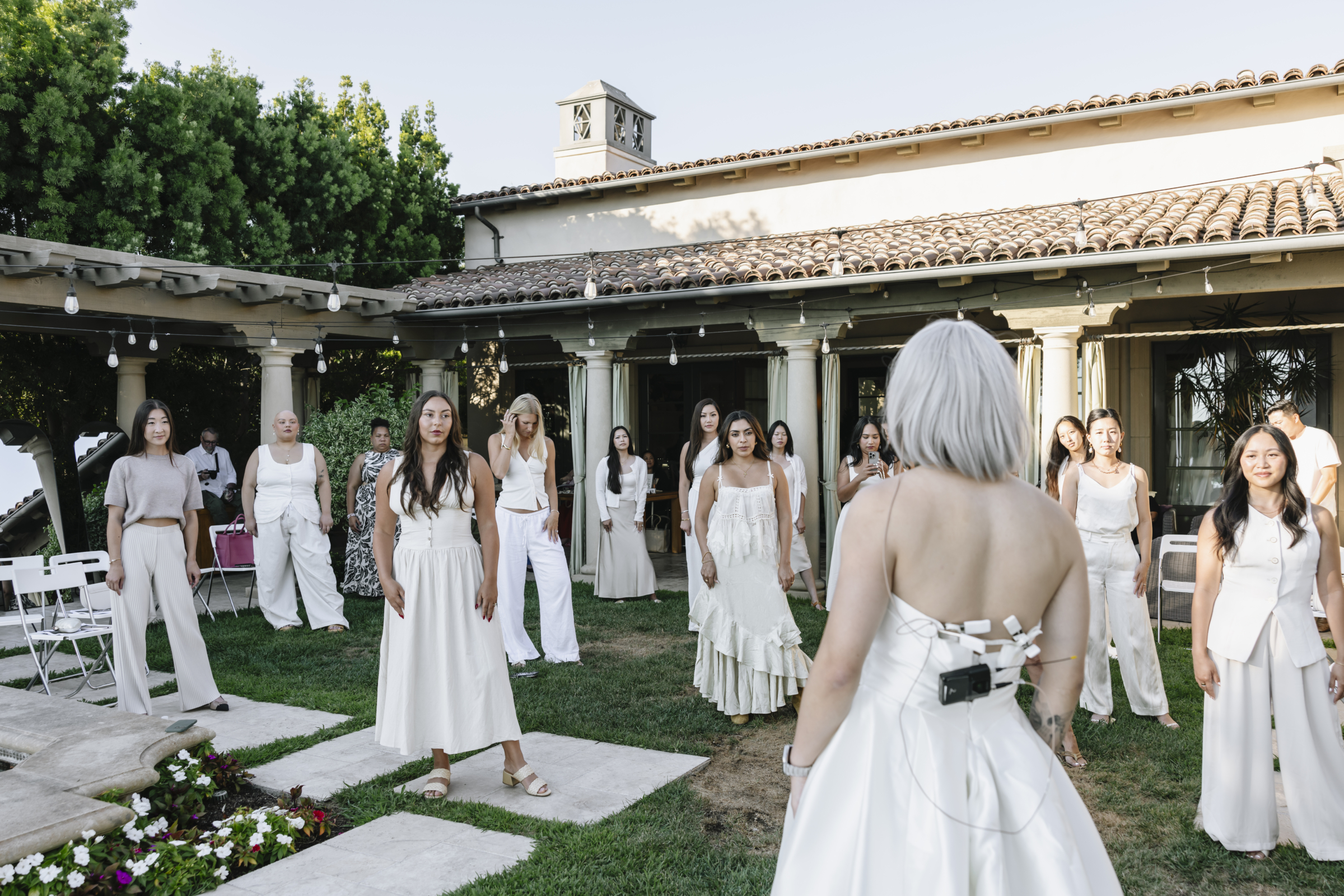 David Suh helping brides of all sizes pose in wedding gowns