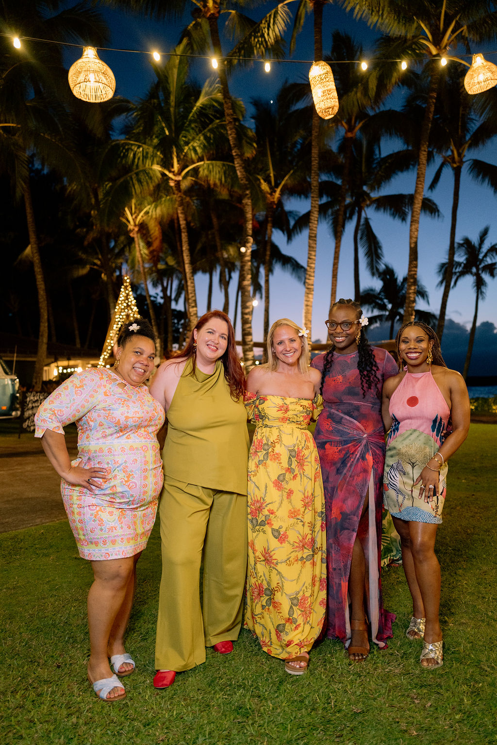 friends at golden hour in hawaii at beach house lawn at The Ritz-Carlton Maui, Kapalua
